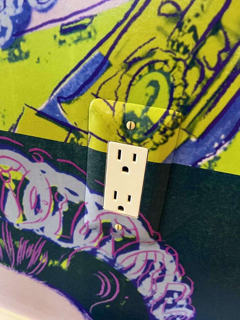 wallpaper pattern flowing seamlessly around outlet