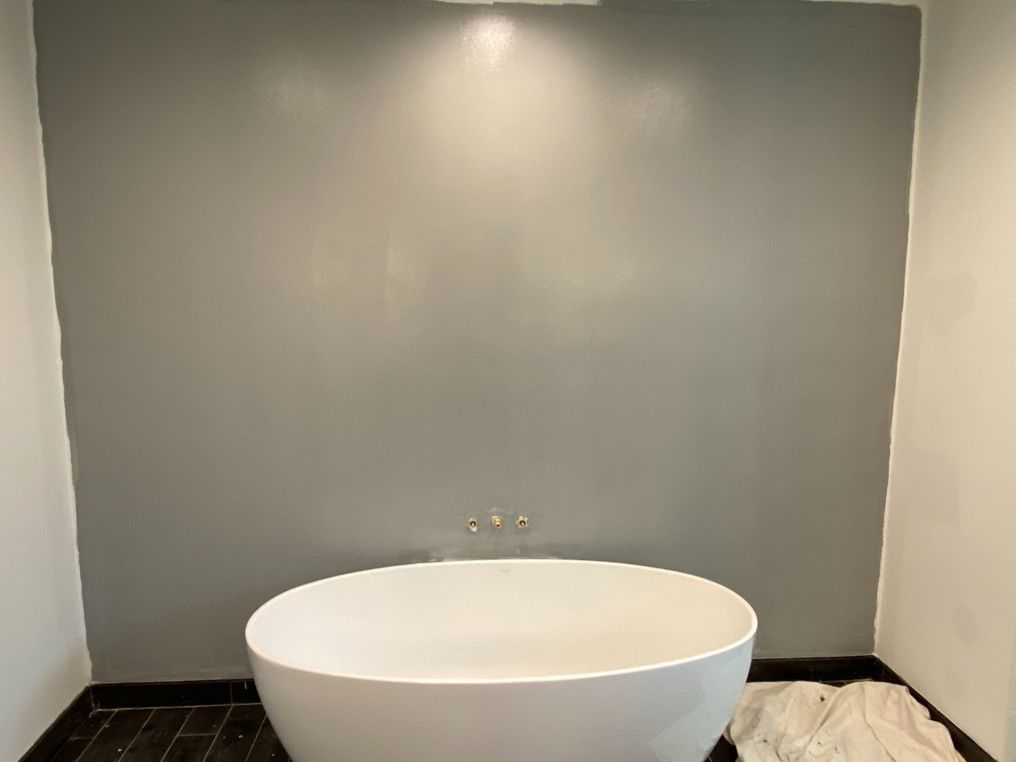 tinted primer applied to wall for wallpaper prep