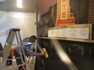 wallpaper installer barry bernau hanging a mural in the State Theatre in Ann Arbor