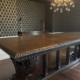 Henry Ford's table from head position looking up showing ornate carved edge with black and gold wallpaper by Bernau Designs