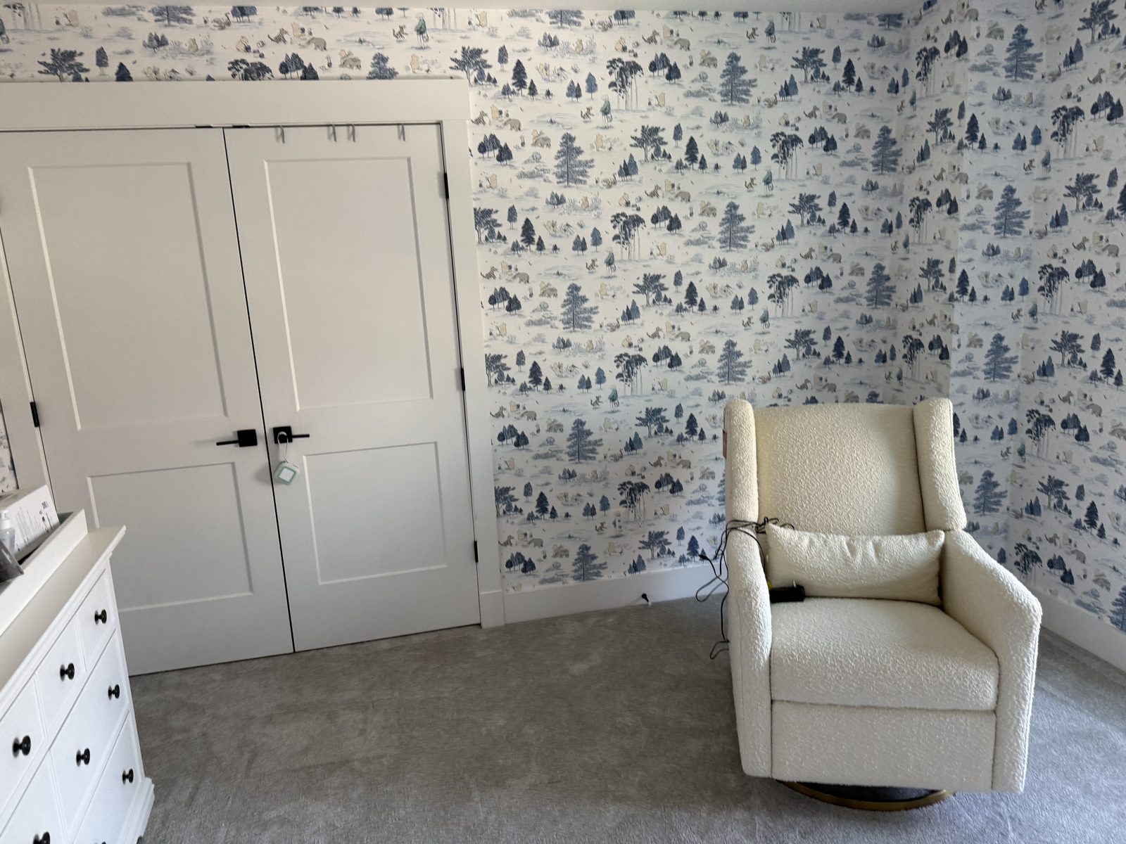 Sanderson Winnie the Pooh wallpaper meeting the closet trim, pattern continuing cleanly on both sides.