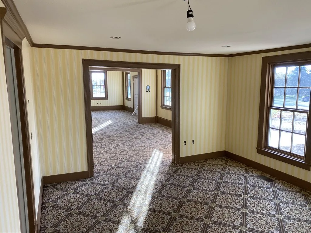 Kensington Stripe wallcovering meeting dark brown trim and a doorway at the Niles-Barnard House, Troy Historic Village.