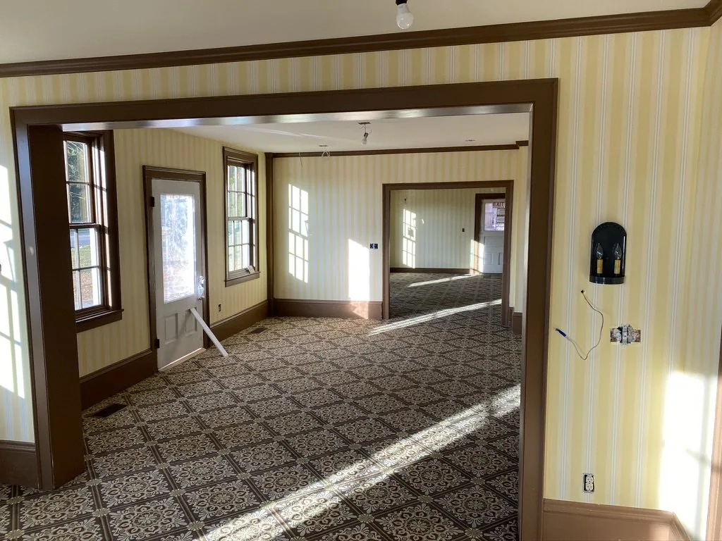 Morning daylight across the Kensington Stripe wallcovering and floor of the restored Niles-Barnard House in Troy, Michigan.